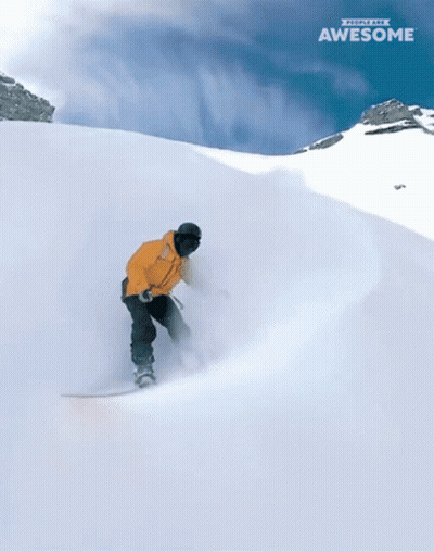 Two Snowboarders Are Going Down A Snow Covered Slope And The Word Awesome Is On The Bottom Right GIF