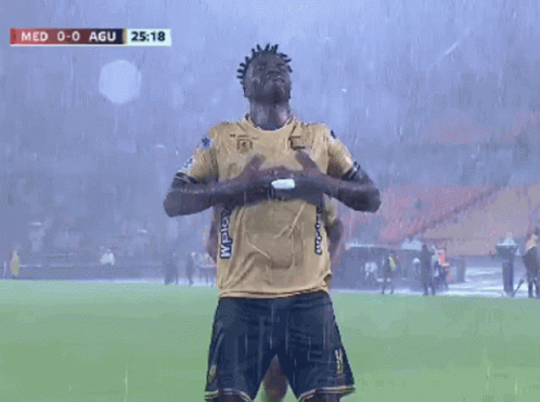 Two Soccer Players Are Celebrating A Goal During A Game Between Med And Agui GIF