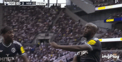 Two Soccer Players Are Celebrating A Goal In Front Of A Crowd And The Score Is Tot 0-2 New GIF