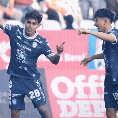 Two Soccer Players Are Celebrating A Goal In Front Of An Off Deep Sign GIF