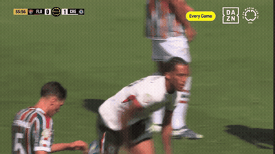 Two Soccer Players Are Celebrating A Goal With A Free Da Zn Logo In The Background GIF