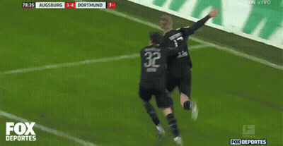 Two Soccer Players Are Celebrating A Goal With The Fox Deportes Logo Behind Them GIF