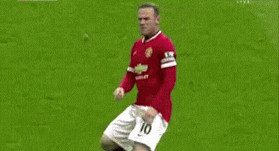 Two Soccer Players Are Fighting For The Ball On A Field . One Of The Players Has The Number 18 On His Shirt . GIF