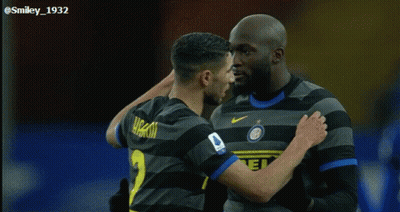 Two Soccer Players Are Hugging Each Other And One Has The Number 1 On His Shirt GIF