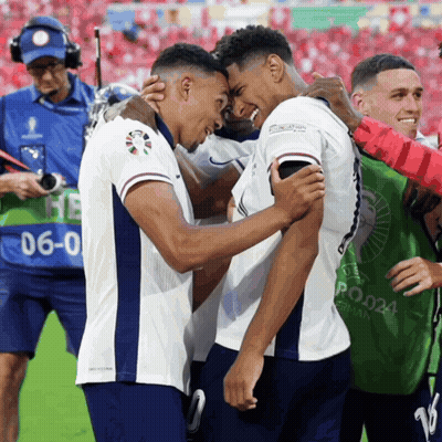 Two Soccer Players Are Hugging Each Other And One Has The Number 6 On His Back GIF