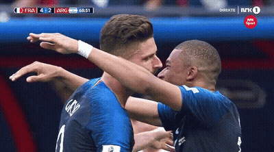 Two Soccer Players Are Hugging Each Other During A Game Sponsored By Nrk Sport GIF