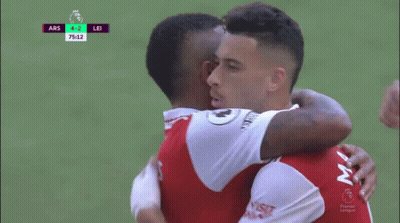 Two Soccer Players Are Hugging Each Other During A Game With The Score At 4-2 GIF
