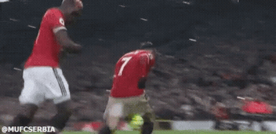 Two Soccer Players Are Kneeling Down On The Field . GIF