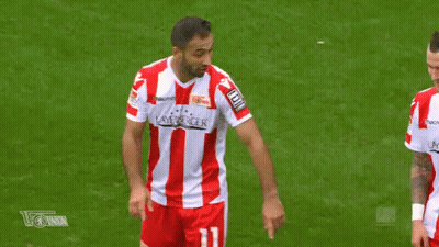 Two Soccer Players Are Making A Heart Shape With Their Fingers On The Field . GIF