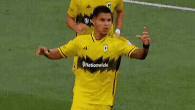 Two Soccer Players Are Making A Heart Shape With Their Hands On A Field . GIF