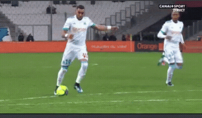 Two Soccer Players Are On A Field With An Orange Sign In The Background . GIF