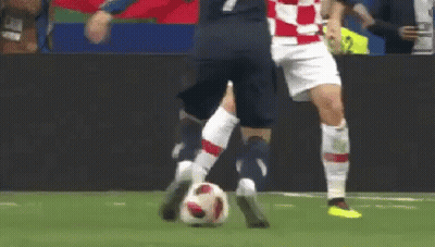 Two Soccer Players Are Playing A Game Of Soccer And One Of Them Is Kicking The Ball . GIF