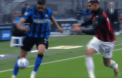 Two Soccer Players Are Playing A Game Of Soccer On A Field GIF