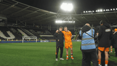 Two Soccer Players Are Posing For A Picture On A Field With A No Sweat Advertisement In The Background GIF