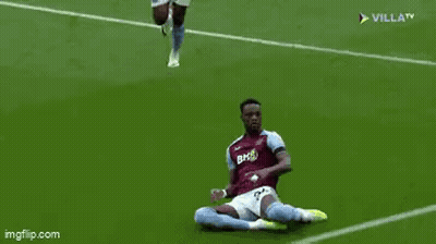 Two Soccer Players Are Running On A Soccer Field And One Of Them Is Wearing Shorts . GIF