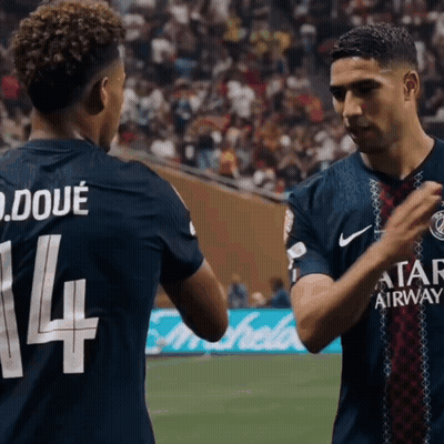 Two Soccer Players Are Shaking Hands And One Has The Number 14 On His Jersey GIF