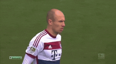Two Soccer Players Are Shaking Hands On The Field And One Has The Number 12 On His Shirt GIF