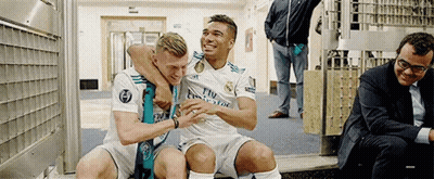 Two Soccer Players Are Sitting Next To Each Other In A Locker Room . GIF