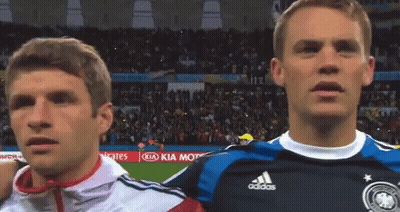Two Soccer Players Are Standing Next To Each Other In Front Of A Kia Kia Motors Advertisement GIF
