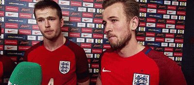 Two Soccer Players Are Standing Next To Each Other In Front Of A Wall With Nike Advertisements GIF