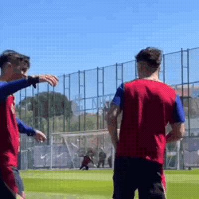 Two Soccer Players Are Standing On A Field And One Of Them Is Pointing At The Other . GIF