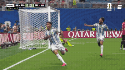 Two Soccer Players Celebrate A Goal In Front Of An Ad For Qatar GIF