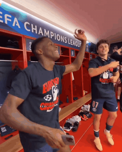 Two Soccer Players Celebrate Champions League Sign GIF