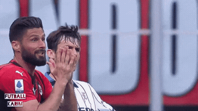 Two Soccer Players Clapping In Front Of Futball Karim Sign GIF