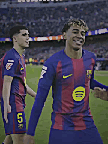 Two Soccer Players Dancing On Field, One In Spotify Shirt GIF
