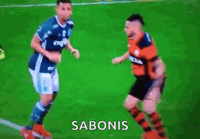 Two Soccer Players Fighting With Sabonis On Screen GIF