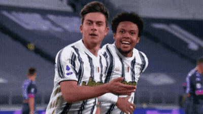 Two Soccer Players Hugging After Goal GIF