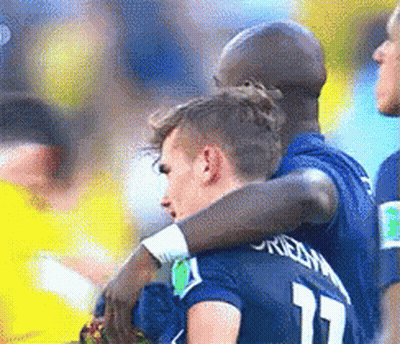 Two Soccer Players Hugging Each Other With One Wearing The Number 17 GIF