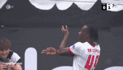 Two Soccer Players Hugging In Front Of Scoreboard Saying 0 GIF