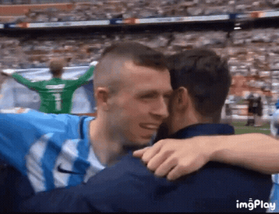 Two Soccer Players Hugging In Stadium With Number 1 On Jersey GIF