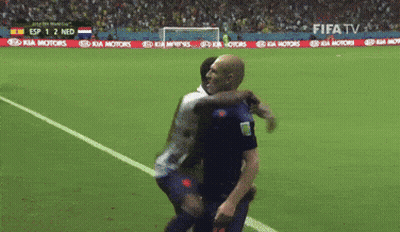 Two Soccer Players Hugging On A Field With A Kia Motors Banner In The Background GIF