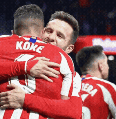 Two Soccer Players Hugging One Wearing Koke Shirt GIF