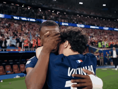 Two Soccer Players Hugging One Wearing Number 2 GIF