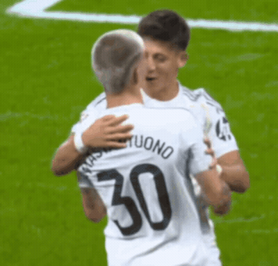 Two Soccer Players Hugging, One With Number 50 GIF