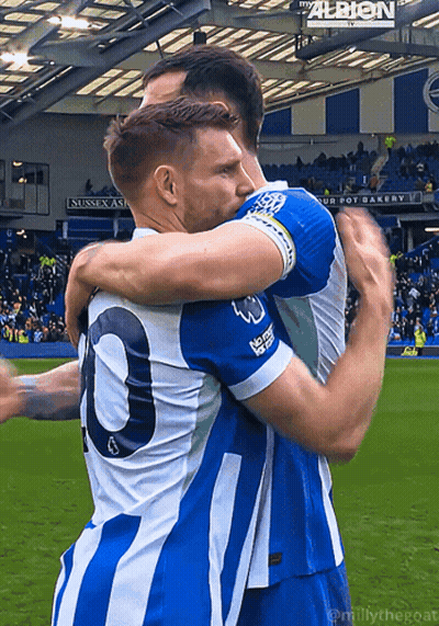 Two Soccer Players Hugging With Albion Sign GIF