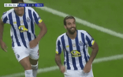 Two Soccer Players In Blue And White Striped Jerseys Are Running On A Field . GIF