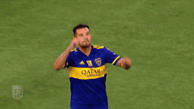 Two Soccer Players In Blue And Yellow Jerseys Are Hugging Each Other On A Field . GIF