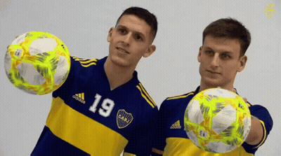 Two Soccer Players In Blue And Yellow Jerseys Number 19 GIF