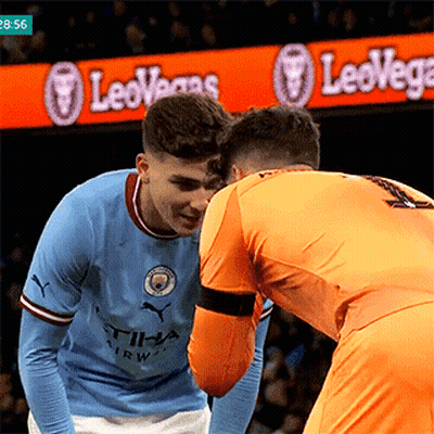 Two Soccer Players In Front Of LeoVegas Sign GIF
