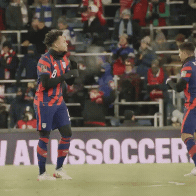 Two Soccer Players In Front Of Soccer Sign GIF