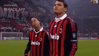 Two Soccer Players In Red And Black Jerseys Saying Win GIF