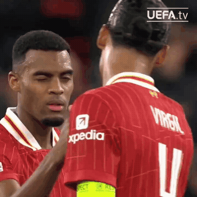 Two Soccer Players In Red Jerseys GIF