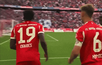 Two Soccer Players In Red Jerseys 19 And 6 GIF
