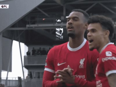 Two Soccer Players In Red Jerseys GIF