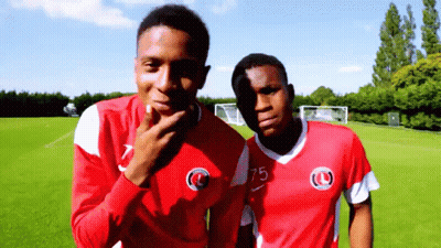 Two Soccer Players In Red Jerseys Number 75 GIF