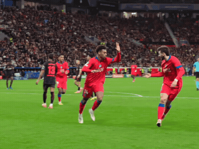 Two Soccer Players in Red Qatar Jerseys Celebrate